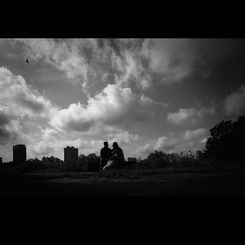 Couple laughing at Kumortuli — artistic pre‑wedding photography